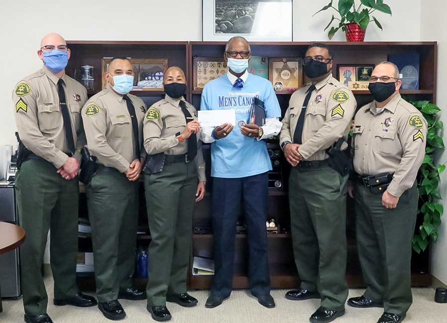 picture of Chief LaJuana Haselrig presented a generous donation to Freddie Muse Jr., President/C.E.O. of The Men’s Cancer Network