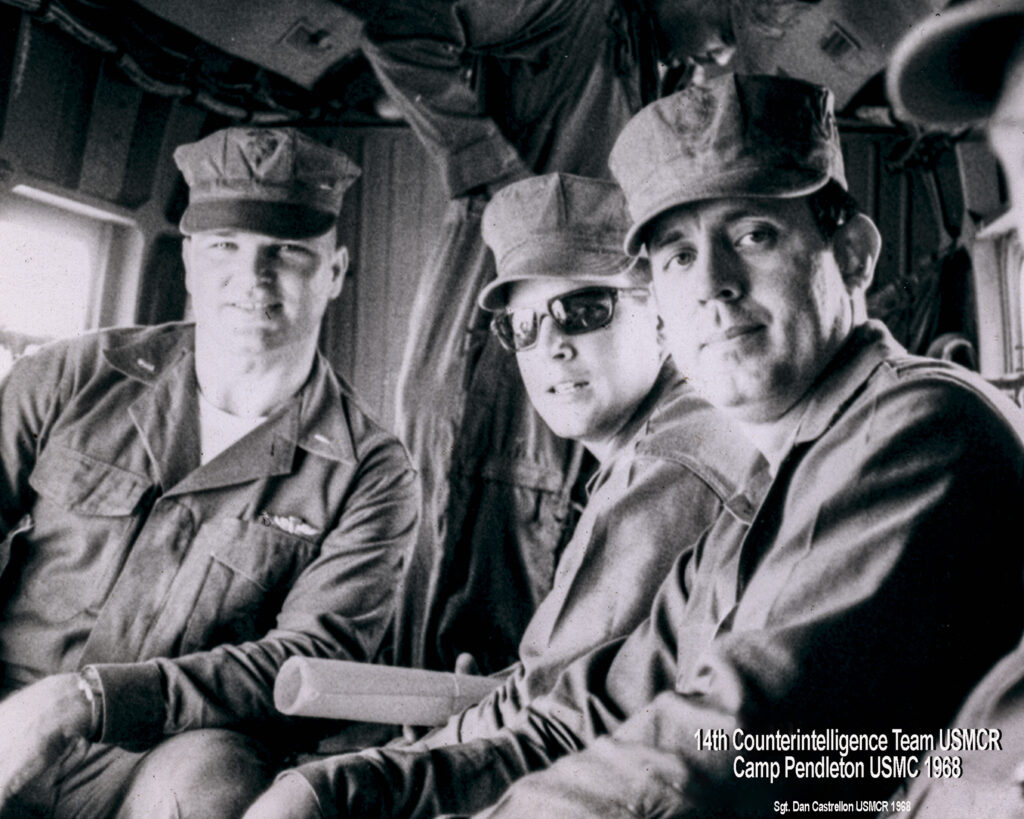 image of vetter next to two marines inside of a heliocoptor. Vintage black and white image. 