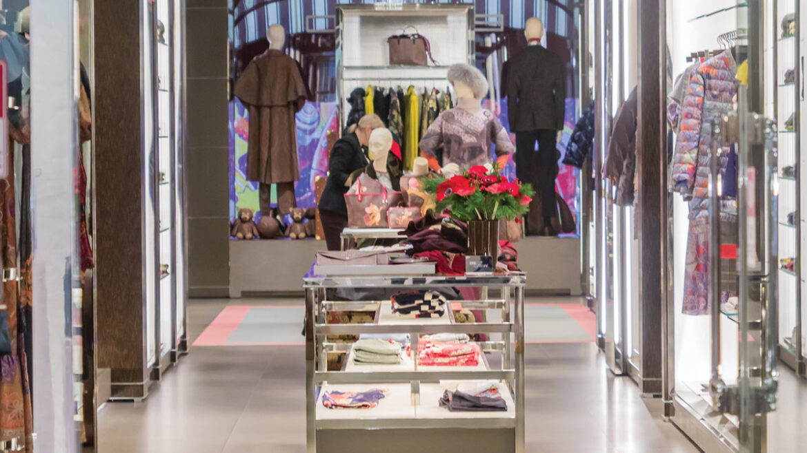 text reads, "Crime trend update: Retail theft mobs". image of a store front with well lit shelves and designer clothes are on maniquins and folded neatly on shelves.