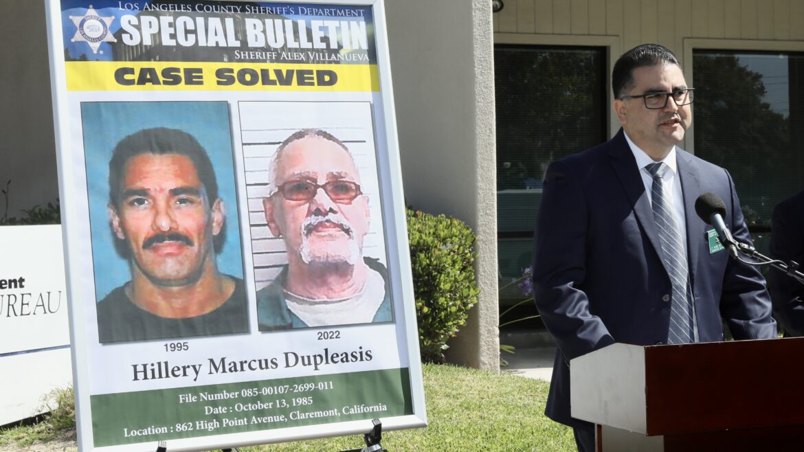 Image of LASD Leutenant standing at a podium with a flyer that reads Case Solved.