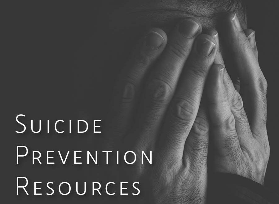 black and white image of a person with their hands folded over their face. words accross the top read "you are not alone". The next line reads " Suicide Revention Resources".