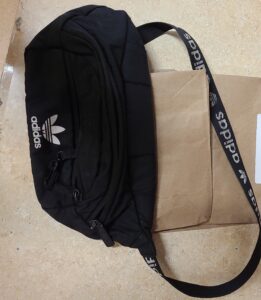 Black chest bag with elastic band.