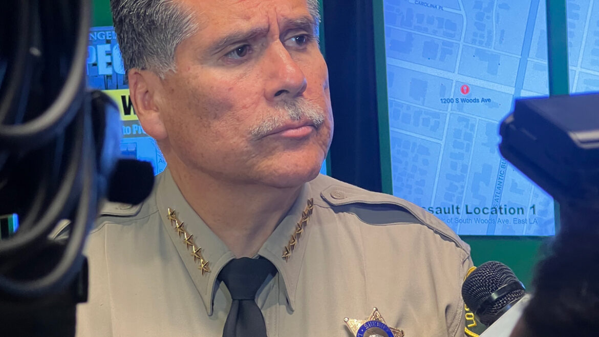 Sheriff Robert Luna Standing in uniform answering questions from media.